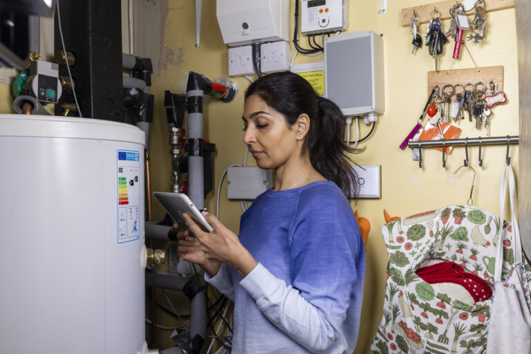 Woman Standing In Front Of Water Heater