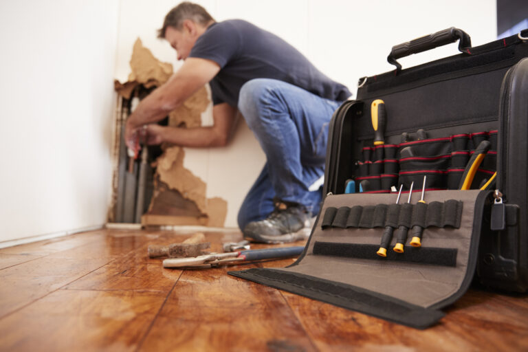 Plumber Repairing Burst Pipe