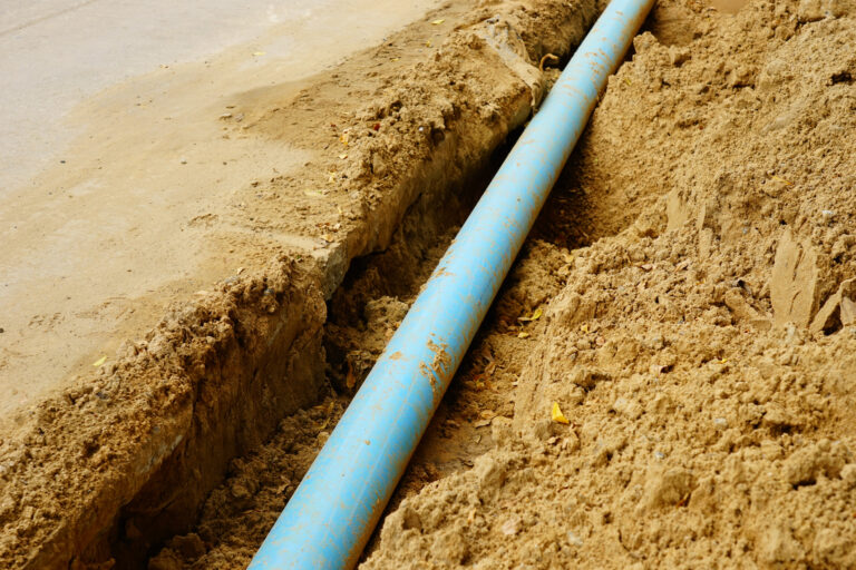 Long blue plastic sewer pipes on road - Affordable Plumbing Sewer Line Pipe